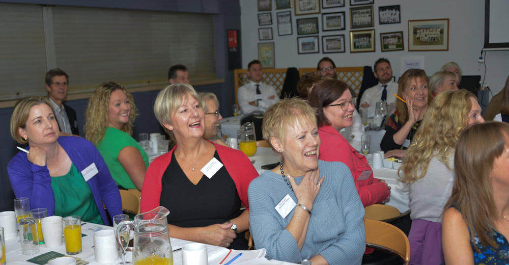 Smiling guests at a Chamber Breakfast